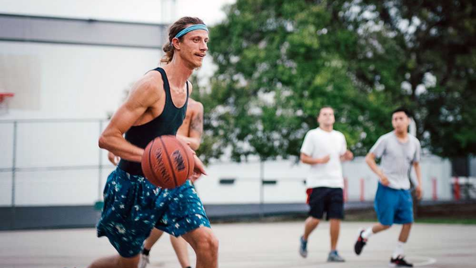 A Resident at the Last House Sober Living in West Los Angeles playing basketball during a saturday house event.
