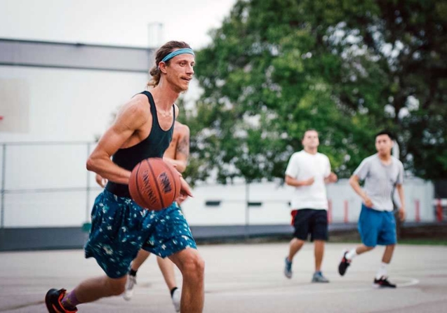A Resident at the Last House Sober Living in West Los Angeles playing basketball during a saturday house event.