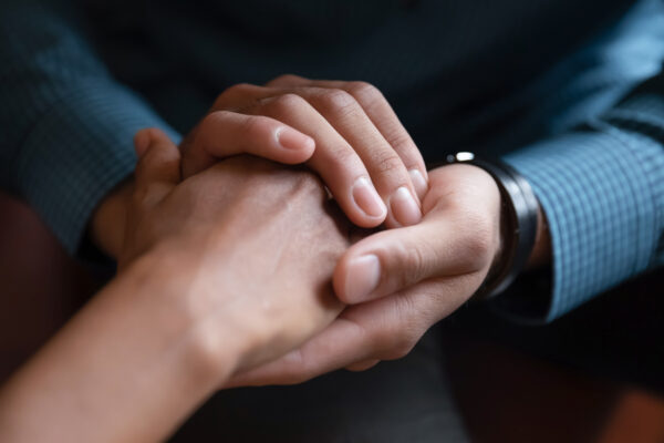 Close,Up,African,American,Man,Comforting,Woman,,Holding,Hands,,Expressing