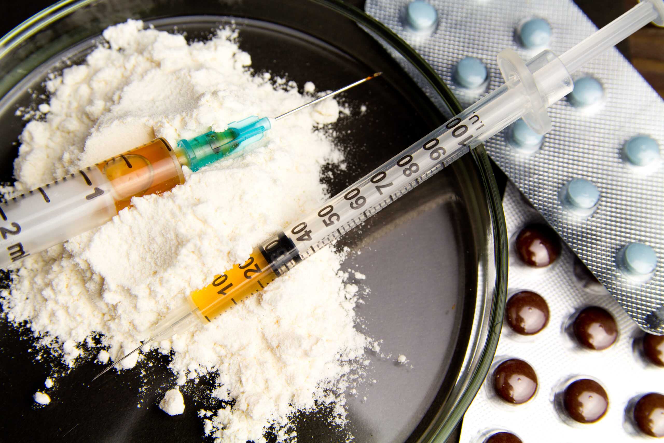 Drugs,And,Syringes,On,Dark,Table.,Opioid,Epidemic,.