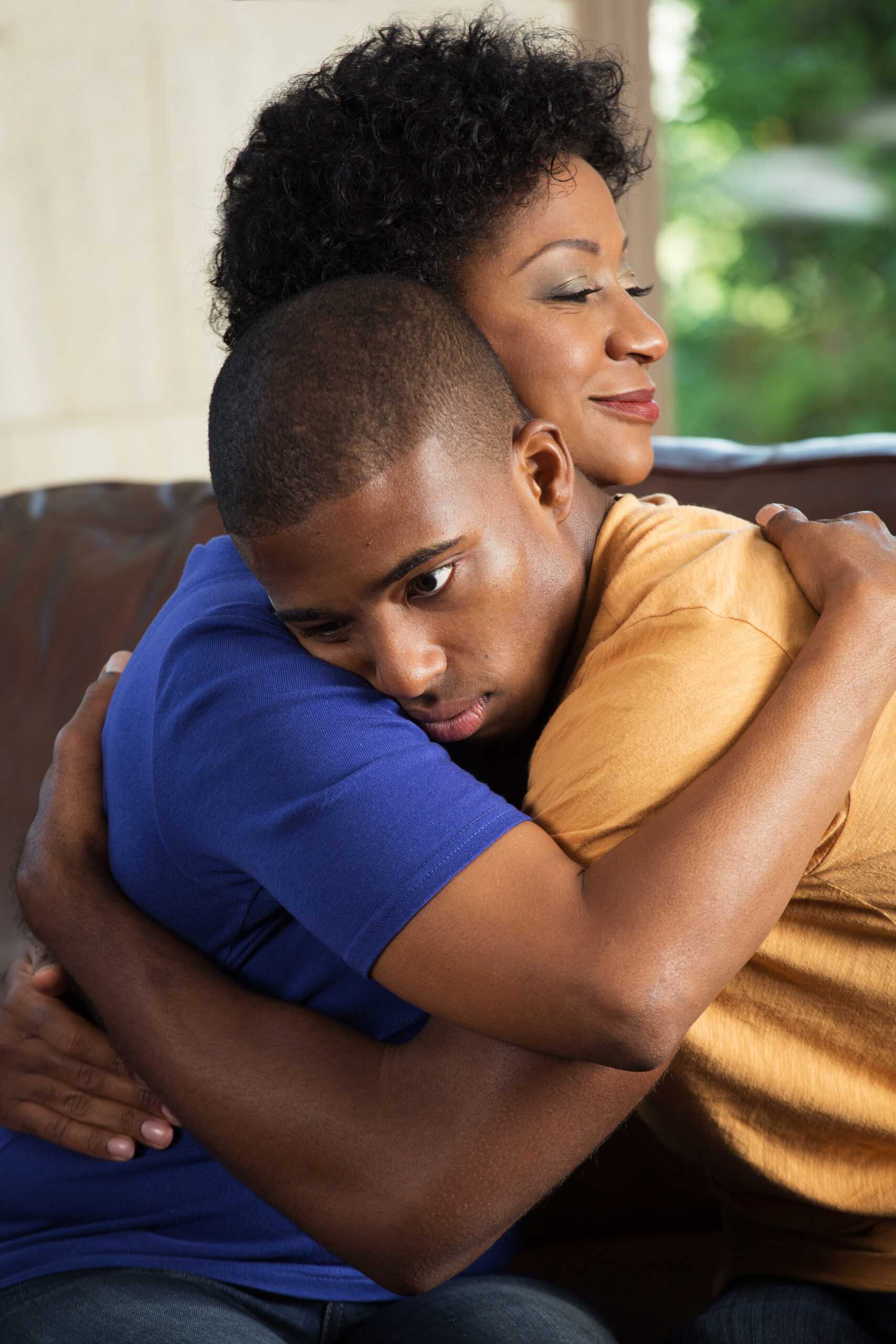 African,American,Mother,Hugging,Her,Adult,Son.