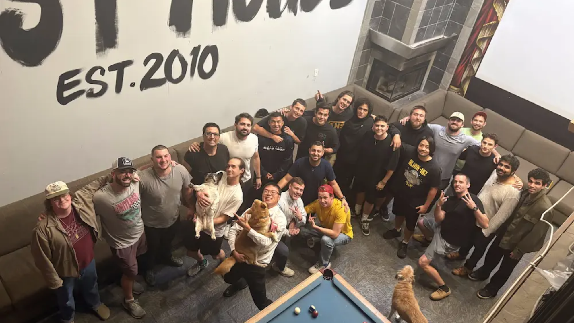 Group of residents and staff celebrating together inside The Last House sober living facility